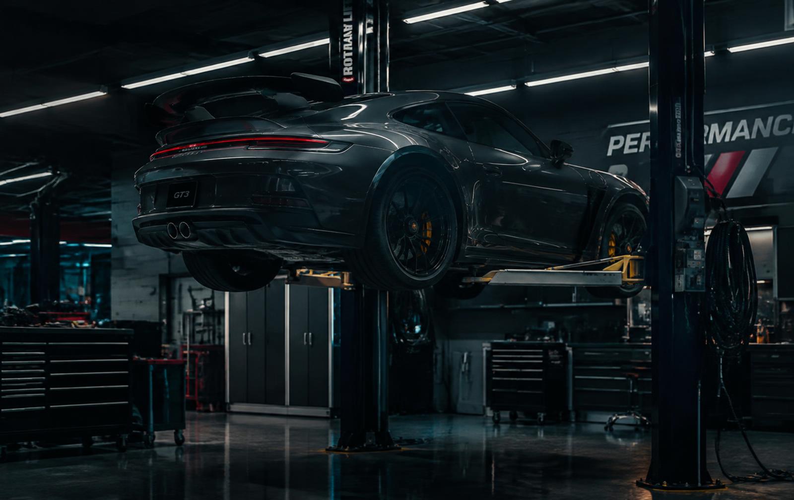 Performance sports car on a lift in a professional automotive workshop
